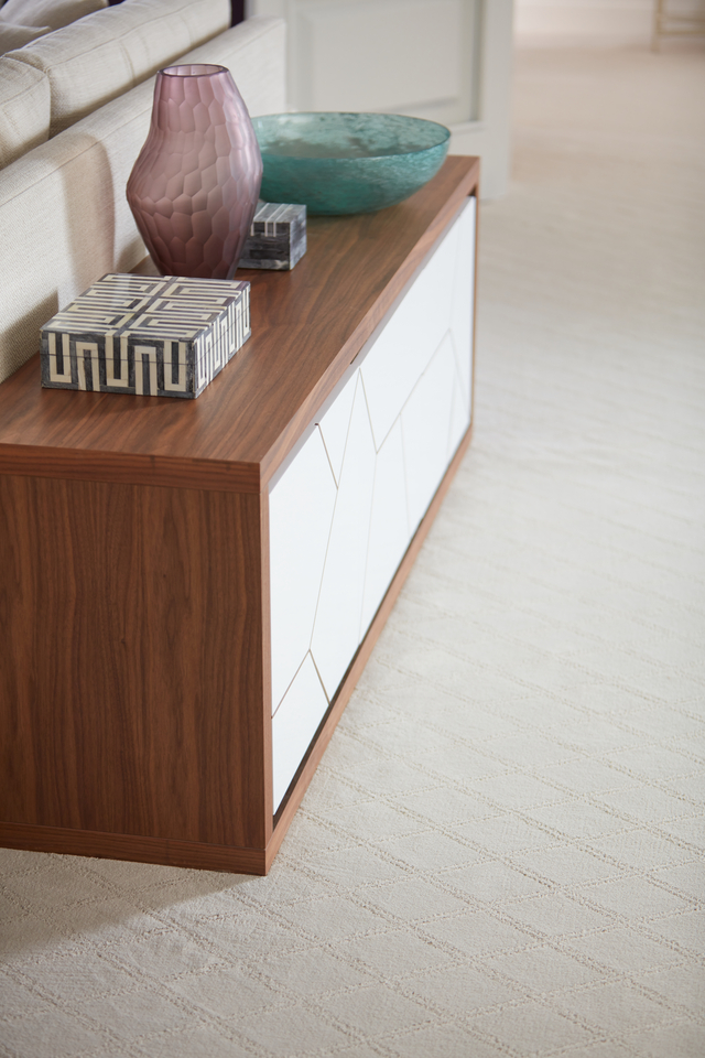 Light beige carpet in living room with wooden furniture 